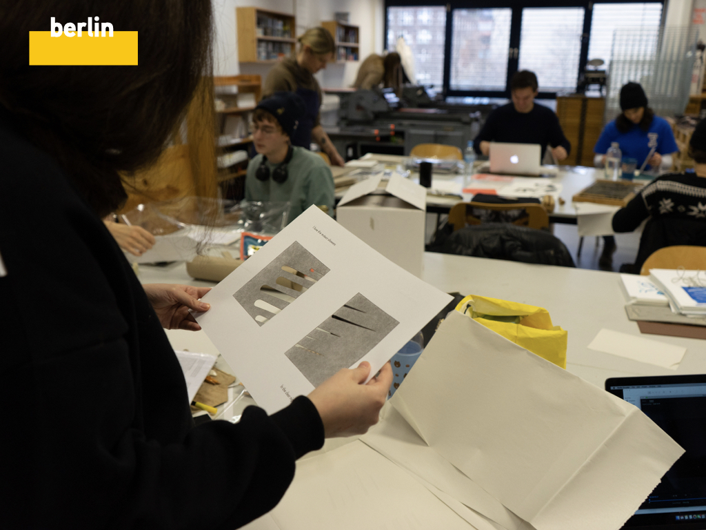 Presentation slide titled berlin, students looking at collaborative prints