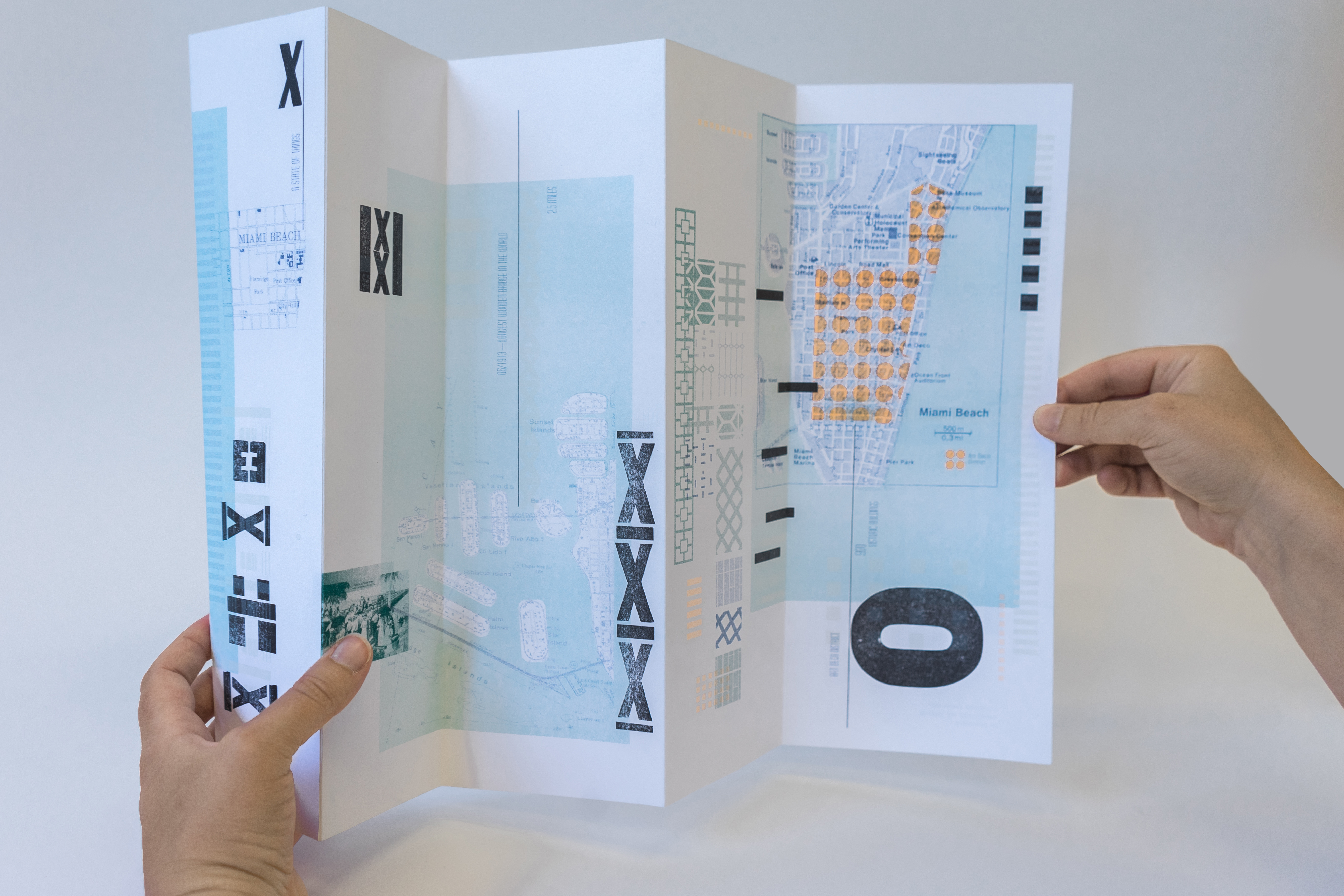 Hands holding the accordion-fold artist book open