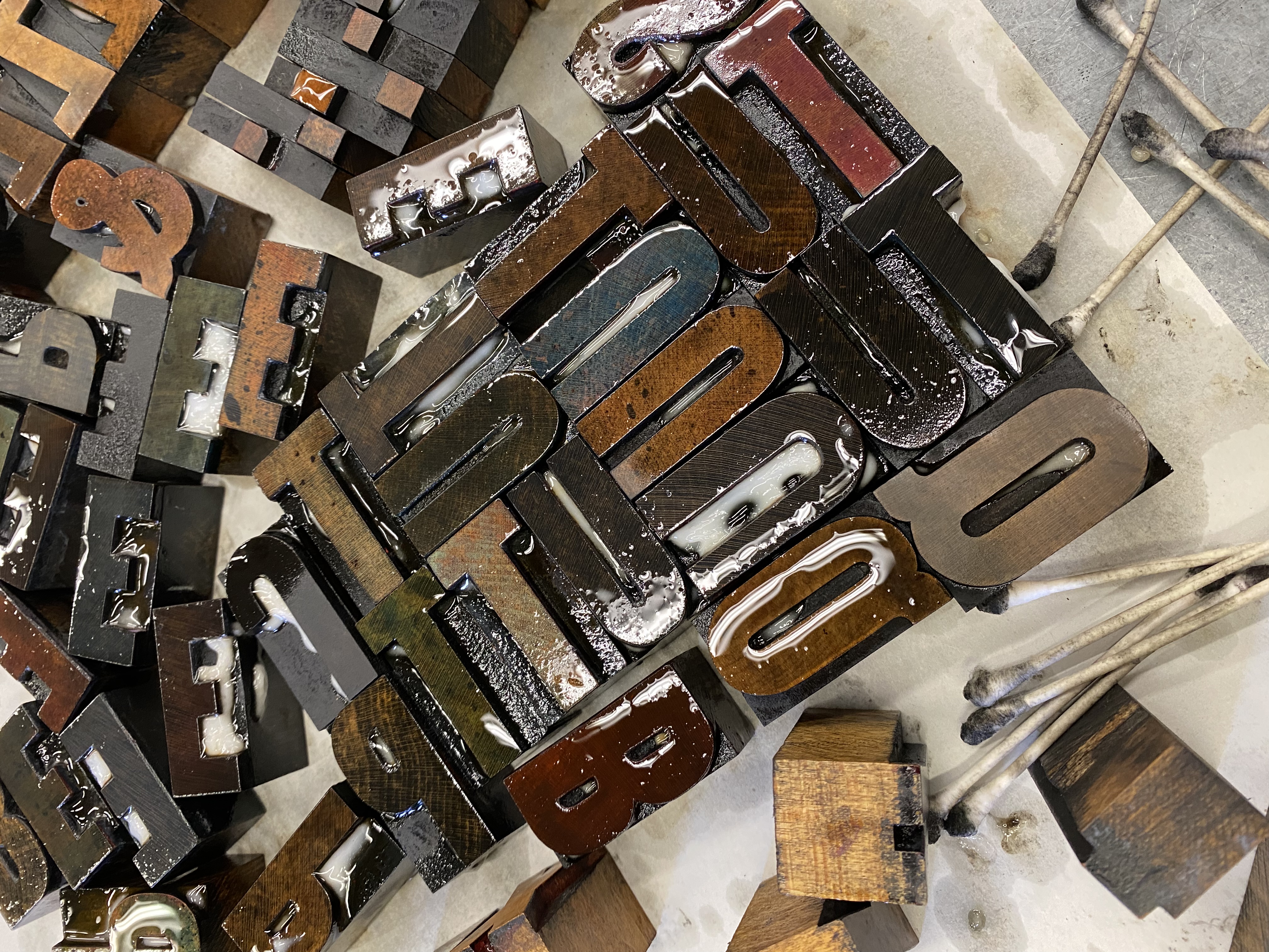 A pile of inked wood type letters