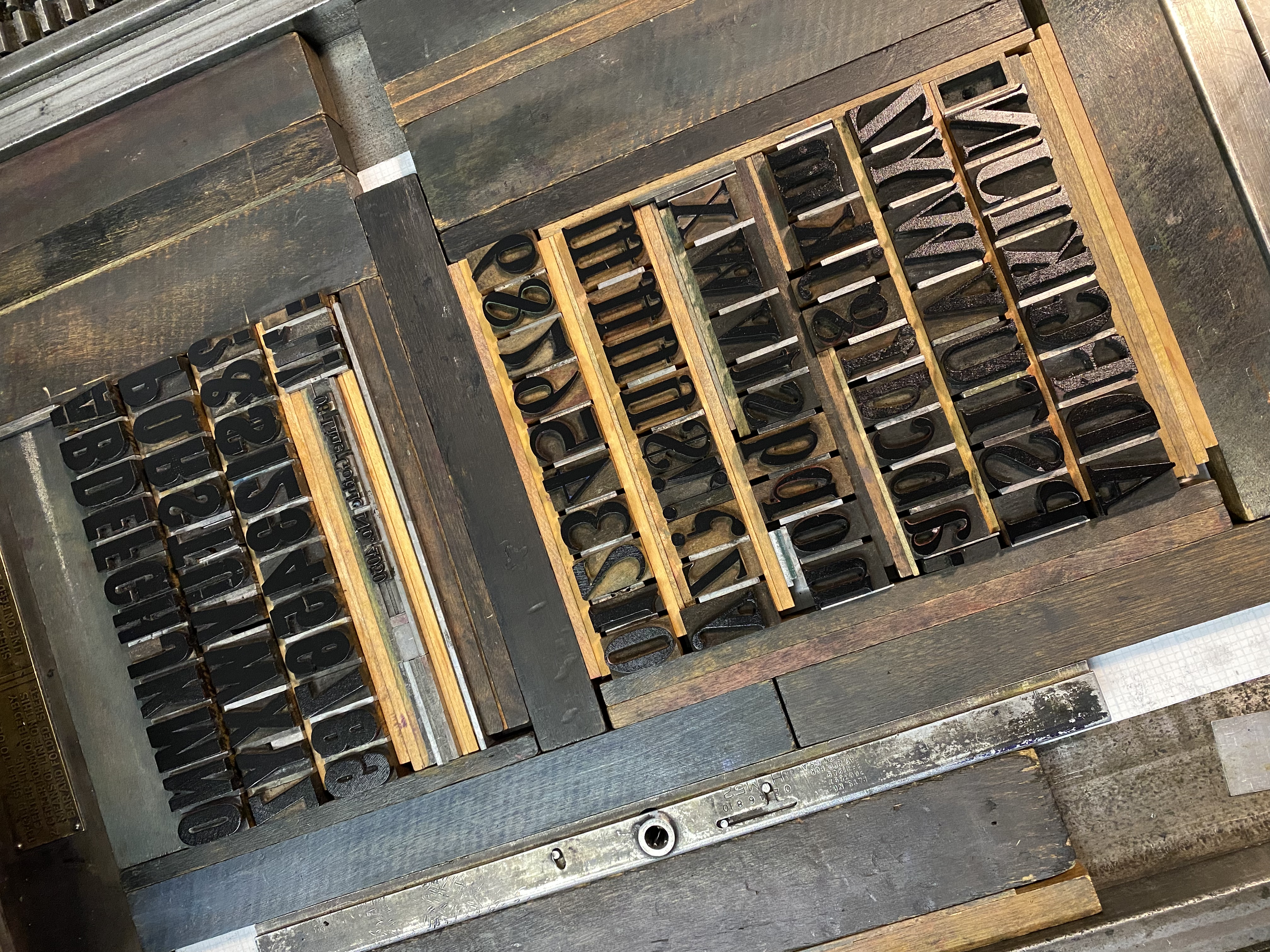 Wood type alphabet arranged in a type case