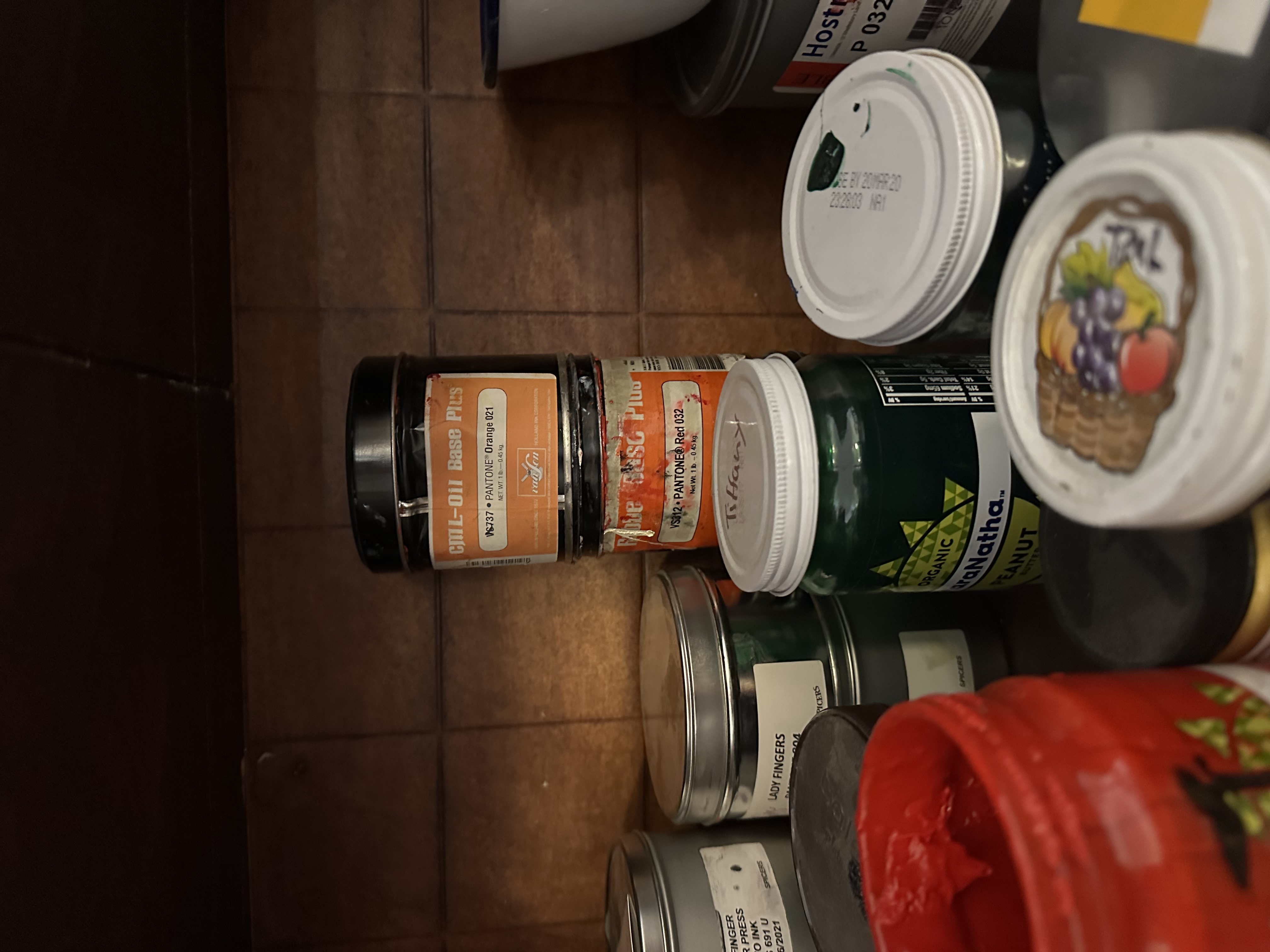 Ink tins on a studio shelf